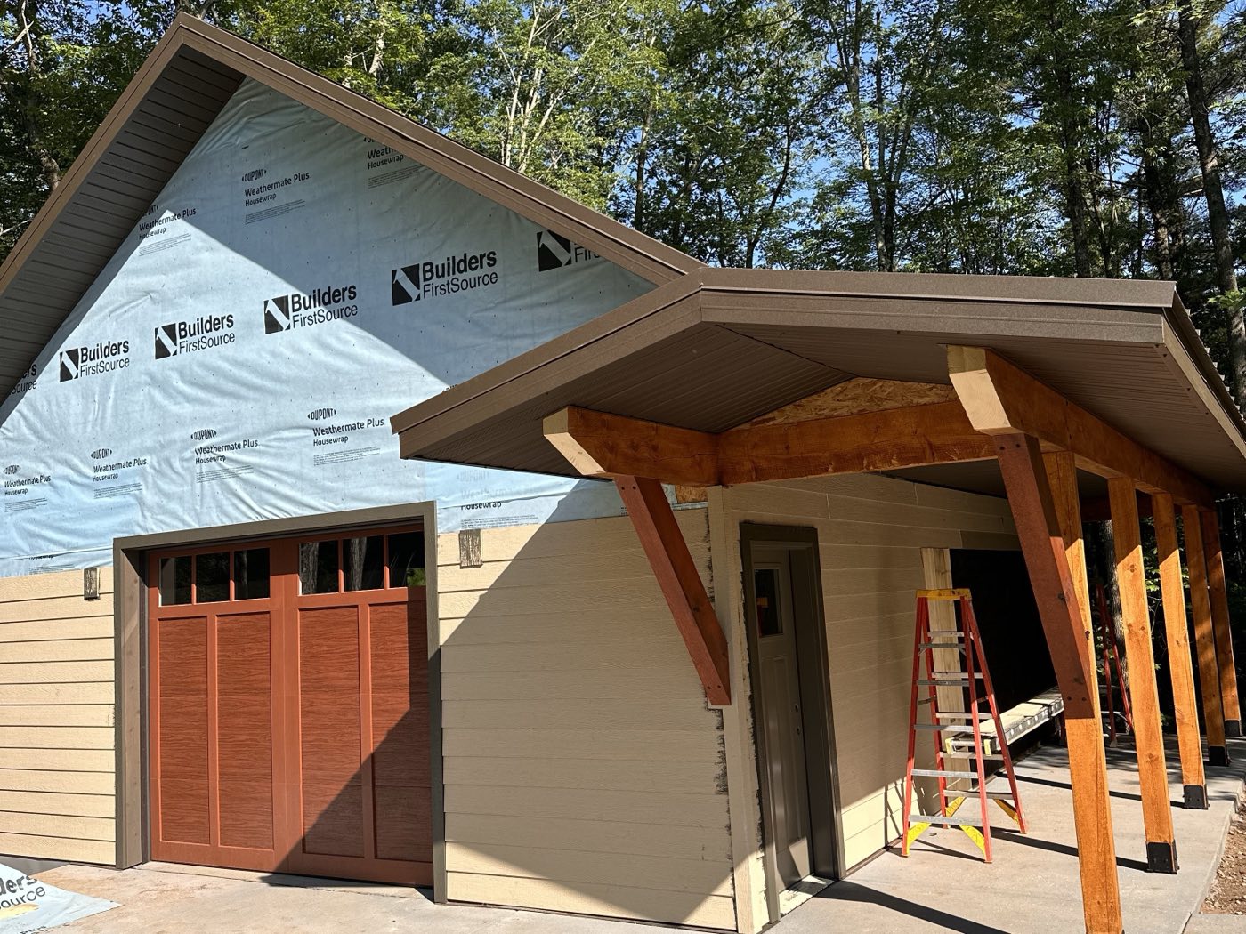 New detached garage with a timber-post covered walkway and craftsman garage door